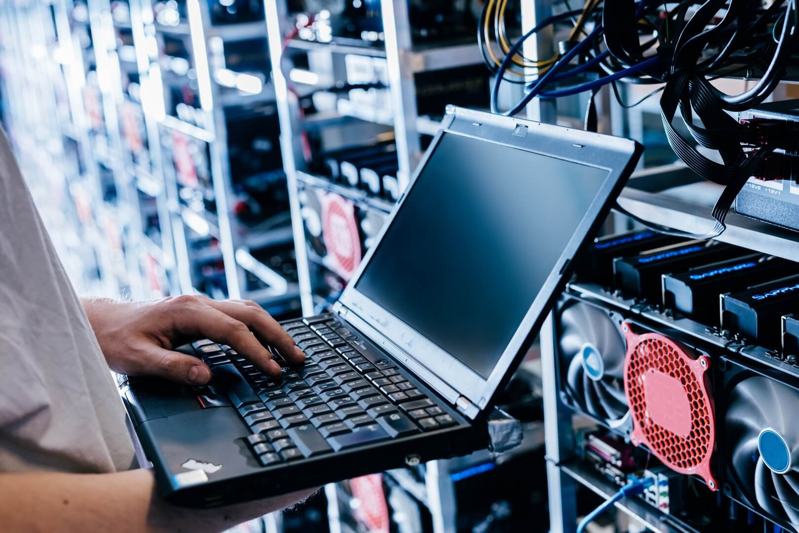 it-specialist-working-on-computer-in-bitcoin-and-crypto-currency-mining-farm